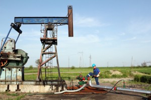 oil worker with wrench on oil field